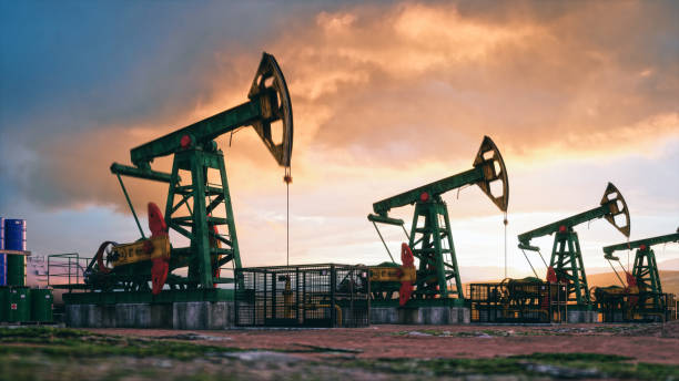 Working oil pumps against a sunset sky.